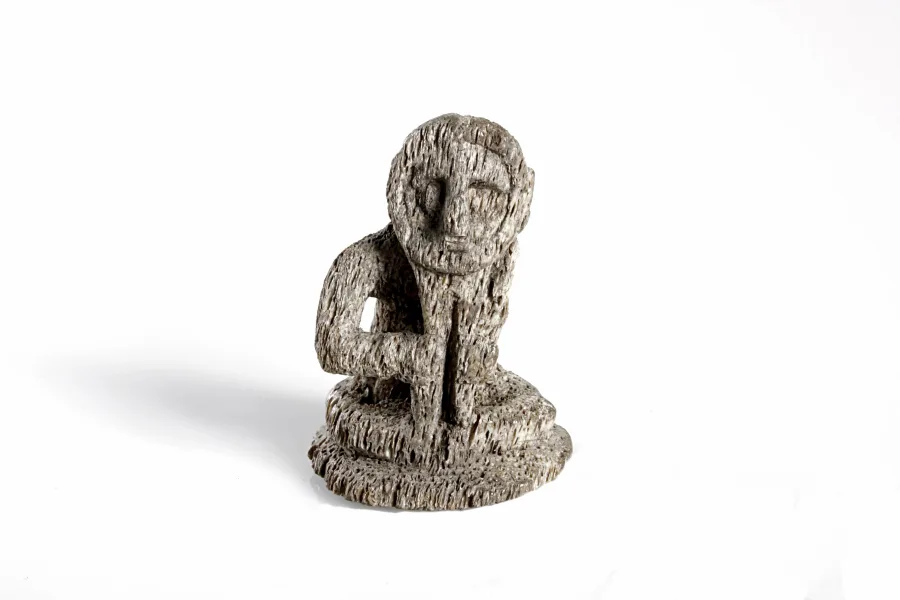 Seated human-like figurine